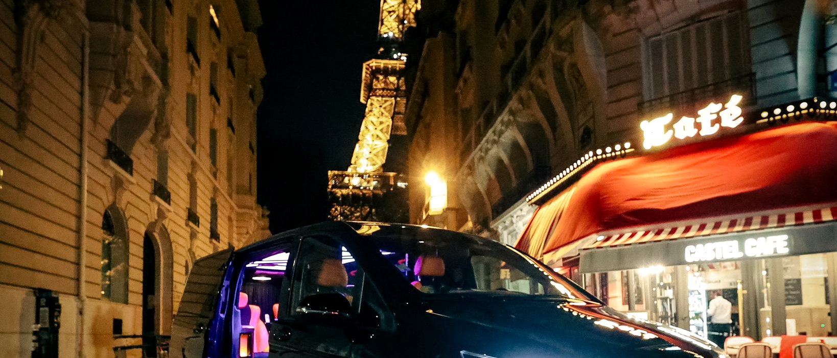 Mercedes chauffeur privé Paris la nuit — Tour Eiffel illuminée depuis une rue parisienne